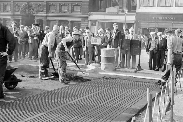 The Mound was proving so hazardous in bad weather to drivers that in 1959 it was decided to lay an 'electric blanket' under the tarmac - which workmen are pictured fitting. The scheme proved less than satisfactory and a few years later was unplugged.