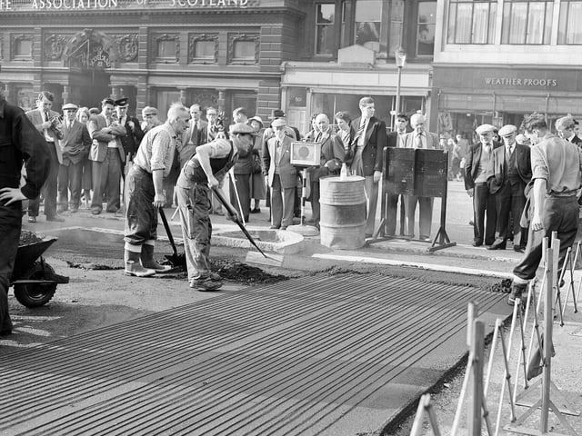 The Mound was proving so hazardous in bad weather to drivers that in 1959 it was decided to lay an 'electric blanket' under the tarmac - which workmen are pictured fitting. The scheme proved less than satisfactory and a few years later was unplugged.