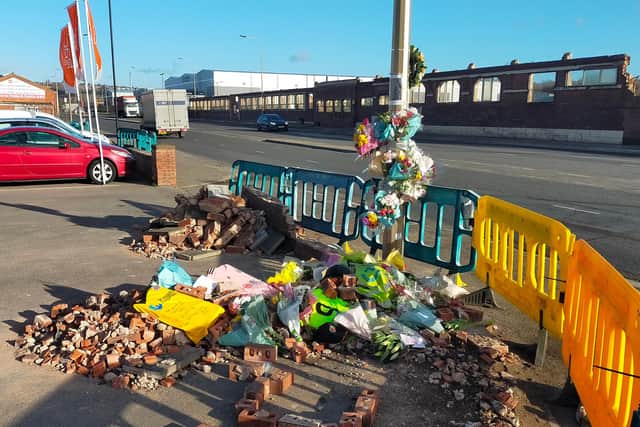 Dozens of bouquets and cards have been left at the scene of the crash on Shepcote Lane.