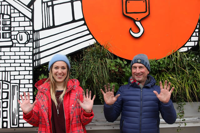 Jo Peel and Nigel Dunnett show off their dirty hands due to the air pollution after pruning the Growing City mural.