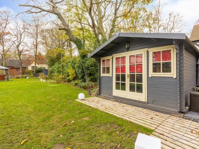 The garden offers lots of outdoor space, including room for outbuildings that can be used for a variety of things.
