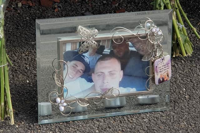 A photograph has been left among floral tributes at a crime scene in Sheffield