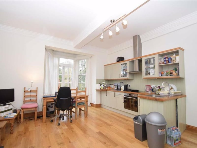 Open-plan living kitchen with double doors to the courtyard.