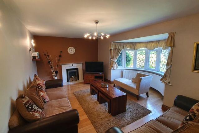 The spacious lounge boasts bay windows and a fire with feature marble surround
