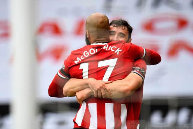 David McGoldrick of Sheffield United celebrates with teammate after scoring his team's first goal during the Premier League match between Sheffield United and Chelsea FC at Bramall Lane: Peter Powell/Pool via Getty Images