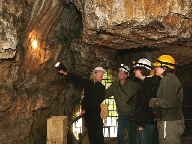 John Charlesworth, Creswell Crags' Principal Heritage Ranger pictured in Robin Hoods Cave with visitors back in 2006