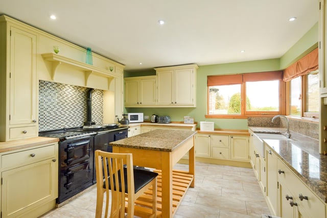 The L-shaped kitchen/family room has a double-oven AGA, granite worktops and a dining area,  as well as a wood-burning stove and doors leading to the garden