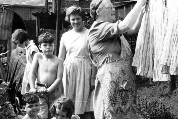 Pegging out the washing with some little helpers back in the 1940s