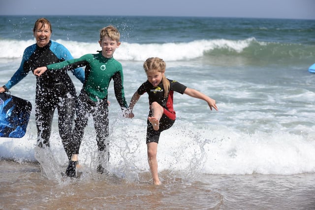 Bo Mizen, eight, with sister Ivy Mizen, six, and grandmother Lynne Green enjoying a dip in the sea at Sandhaven Beach.