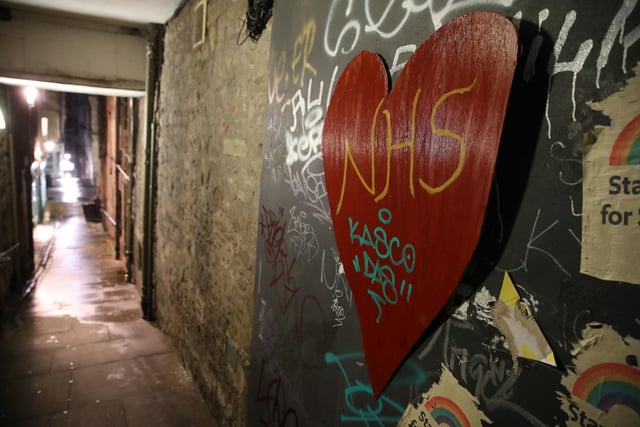 A heart with NHS written on it on the wall of a quiet alleyway in Edinburgh. Photo credit: Andrew Milligan/PA Wire