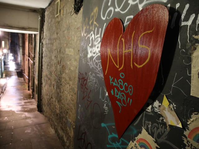 A heart with NHS written on it on the wall of a quiet alleyway in Edinburgh. Photo credit: Andrew Milligan/PA Wire