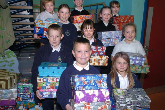 Birley Community Primary School pupils seen with some of the hundreds of gift filled shoe boxes for Operation Christmas Child in 2004