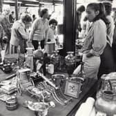 Bed knobs and broomsticks, brasses and bric a brac, a thousand and one objects to be studied and sometimes purchased as shoppers browse among the stalls in the Sheffield Setts Market in 1982