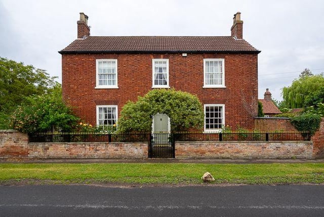 This six bedroom house has three reception rooms and a heated outdoor swimming pool.