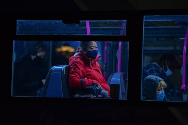 People wearing protective face masks are seen on a bus in Bristol.