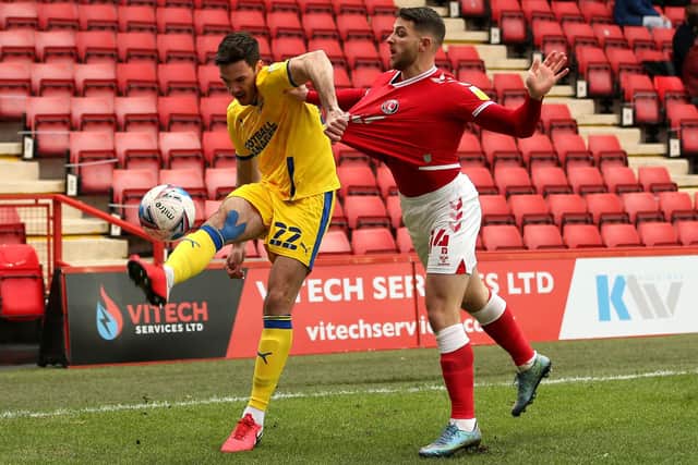 Sheffield Wednesday defender Ben Heneghan (left, playing for AFC Wimbledon) is relishing the challenge of improving the Owls' defence.