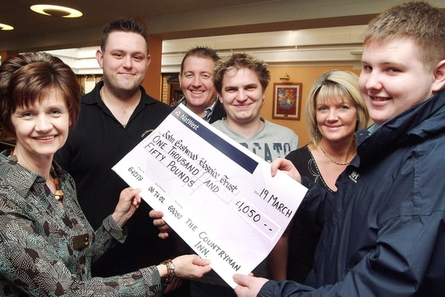 Hospice manager Diane Humprhries, left, is presented with  a £1,050 from continuing left, Graeme Murray, landlord Pete Smith, Ian Butler, landlady Shirley Marriott and Andy Smith after the money was raised at the Countryman Inn pub in Kirkby in February 2008, following various fund raising activities including a leg wax for Graeme, Ian and Andy, a raffle, auction and band night.