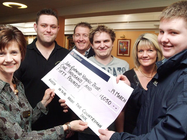 Hospice manager Diane Humprhries, left, is presented with  a £1,050 from continuing left, Graeme Murray, landlord Pete Smith, Ian Butler, landlady Shirley Marriott and Andy Smith after the money was raised at the Countryman Inn pub in Kirkby in February 2008, following various fund raising activities including a leg wax for Graeme, Ian and Andy, a raffle, auction and band night.