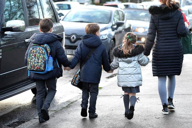 File photo dated 17/01/20 of parents walking their children to school in Hornchurch, Essex, past stationary vehicles near to the school grounds. More than a quarter of British schools, nurseries and colleges are in areas with "dangerously high" levels of pollution, analysis suggests. PA Photo. Issue date: Friday September 11, 2020. Research found 8,549 educational institutions in England, Wales and Scotland ??? some 27% of the total ??? are in areas where the background level of tiny particle pollution known as PM2.5 exceeds international guidelines. See PA story ENVIRONMENT Pollution. Photo credit should read: Nick Ansell/PA Wire