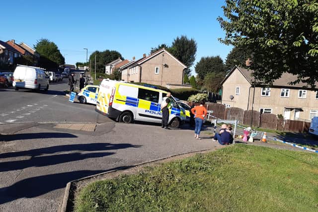 Flowers have been left close to the house where a woman and three children were found dead in Killamarsh yesterday morning