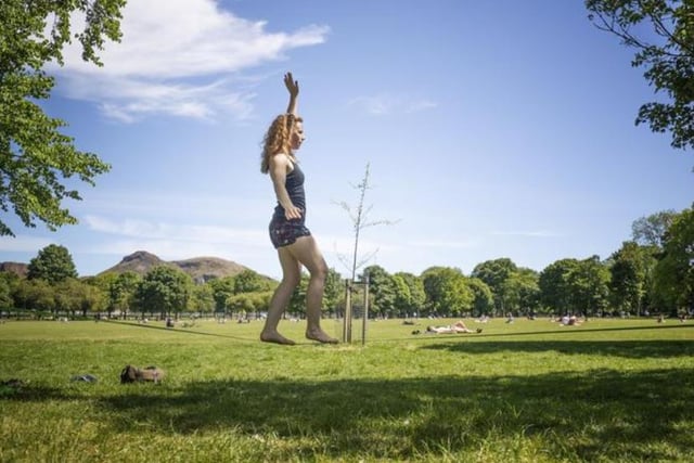 Marie Clare Taggart exercises on a slackline in the good weather in The Meadows, as the public are being reminded to practice social distancing following the relaxation of lockdown restrictions. Photo: Jane Barlow/PA Wire