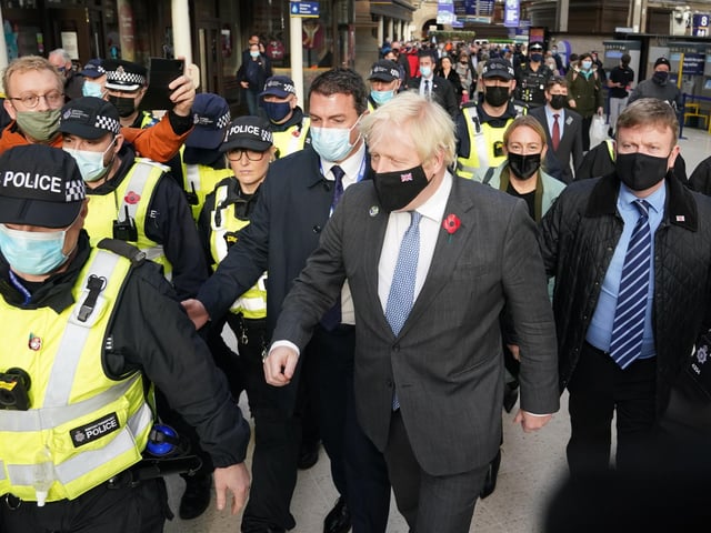 Prime Minister Boris Johnson was escorted by police after he arrived by train from London at Glasgow Central station on his return to the city for meetings at the Cop26 summit. Photo credit: Andrew Milligan/PA Wire