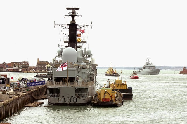 HMS Cardiff (left) - sits alongside South Railway Jetty as the new M.V. Enterprise (right) comes through the Portsmouth Harbour entrance 
17th July 2003 Picture: Malcolm Wells/The New Portsmouth ( 033561-183 )