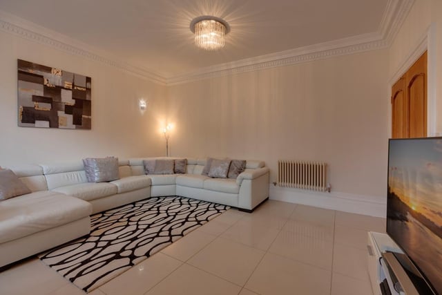 This versatile reception room, with front facing sash windows, could be used as a lounge or for formal dining.