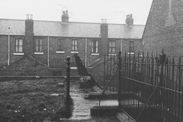 The back of Dene Street showing damaged fencing with the Dale Street Mission Hall on the right. Photo: Hartlepool Museum Service.