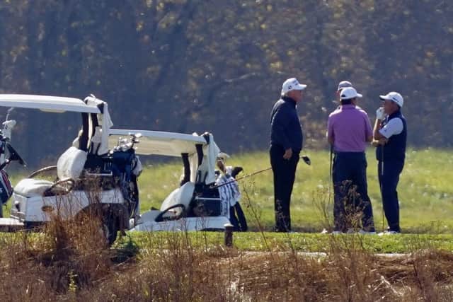 President Donald Trump listens as he participates in a round of golf at the Trump National Golf Course on Saturday, Nov. 7, 2020, in Sterling, Va. (AP Photo/Patrick Semansky)