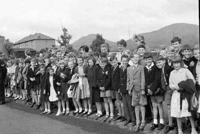 Excited youngsters wait to see the Queen and Duke of Edinburgh, July 1962.