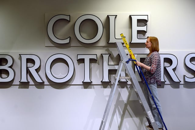 Curator Clara Morgan with a true Sheffield icon, the original 1960s Cole Brothers sign which found a new home on the wall in the Sheffield Life and Times gallery at Weston Park Museum in Sheffield on July 28, 2016