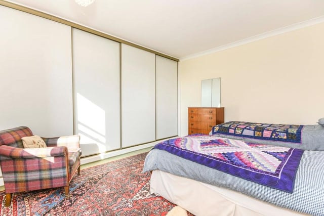 Fitted wardrobes in this bedroom offer plenty of space for clothes and shoes to keep the room clutter-free.