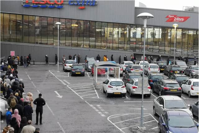 Shoppers queuing outside Tesco in Burngreave, Sheffield, during the coronavirus outbreak.