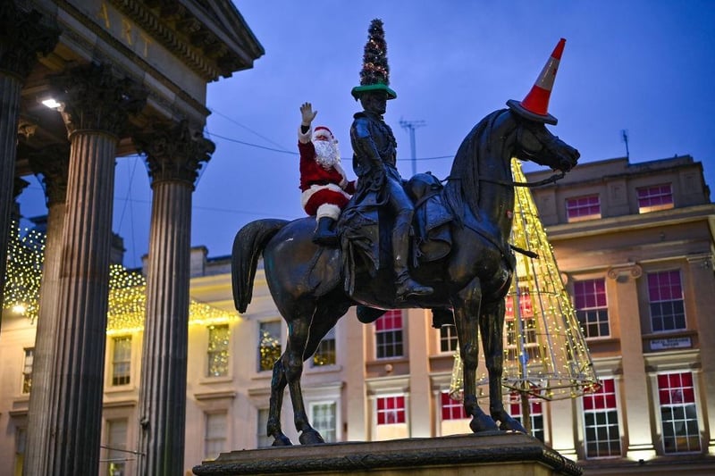 'Santa Claus' scales the Duke of Wellington statue in Glasgow. 