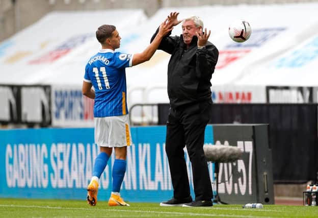 Leandro Trossard of Brighton and Hove Albion interacts with Steve Bruce, Manager of Newcastle United during the Premier League match between Newcastle United and Brighton & Hove Albion at St. James Park on September 20, 2020 in Newcastle upon Tyne, England.