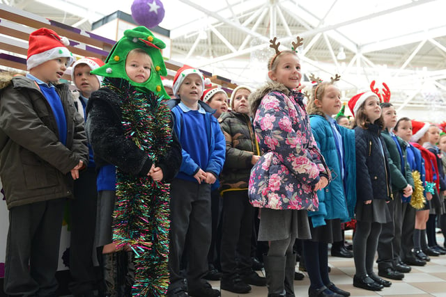 West Park Primary pupils singing Christmas carols in Middleton Grange Shopping Centre 7 years ago. Is there someone you know among them?