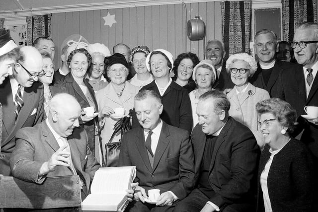The Minister of Colinton Mains Church and his congregation study the presentation hymnal in September 1964.