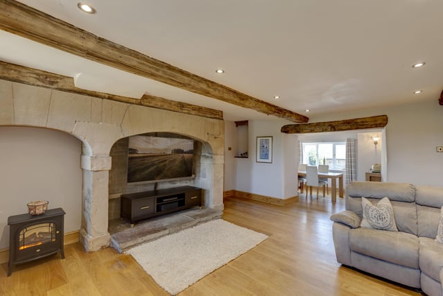 The sitting room is fantastic and finished with sandstone arches on the TV wall. It also has an addition space at the front of the property, currently utilised with a table and chairs.