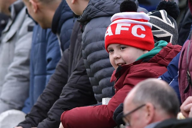 A young supporter watches the action unfold.