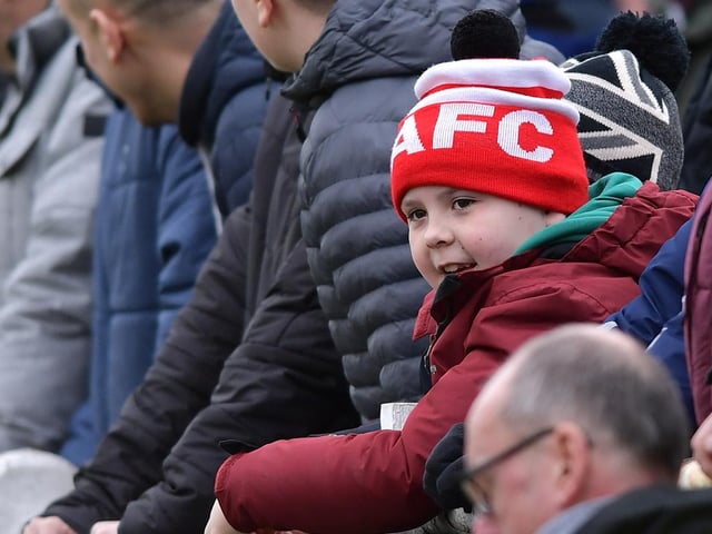 A young supporter watches the action unfold.