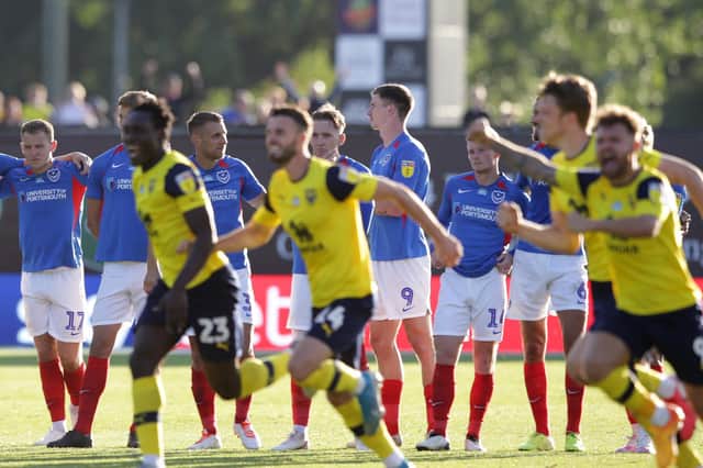 OXFORD, ENGLAND - JULY 06: Portsmouth players look on as Oxford players celebrate winning 5-4 on penalties during the Sky Bet League One Play Off Semi-final 2nd Leg match between Oxford United and Portsmouth FC at Kassam Stadium on July 06, 2020 in Oxford, England. Football Stadiums around Europe remain empty due to the Coronavirus Pandemic as Government social distancing laws prohibit fans inside venues resulting in all fixtures being played behind closed doors. (Photo by Robin Jones/Getty Images)