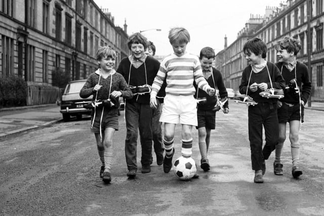 Little boys show off their Xmas presents (including new football boots, a football and a Celtic strip) in McCulloch Street, Pollokshields Glasgow in December 1970.