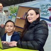 Assistant headteacher James Mills, with Castro Hart-Richards and Vikki Hart, pictured with a laptop at Athelstan Primary School.