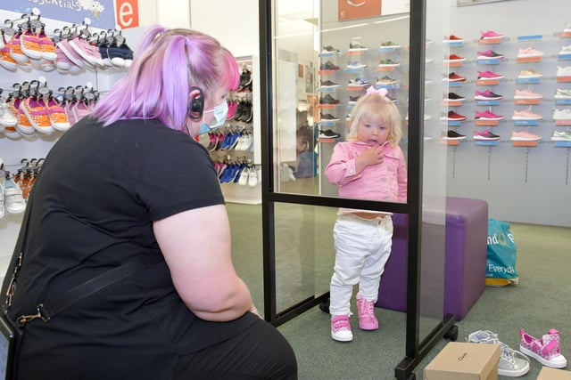 A young shopper checking new footwear in Clarks.