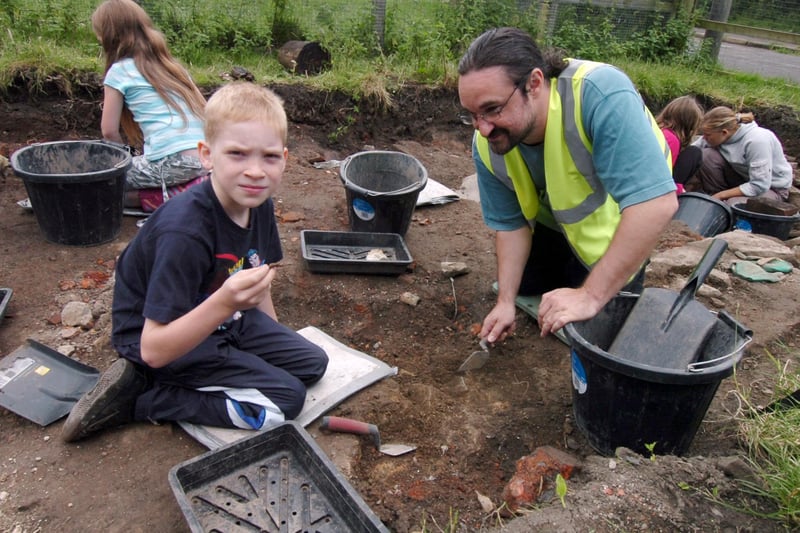 Young archaeologist Oliver Ainscough with Russell Martin-French of archaeology team ARCUS digging at what was once 57 Alexandra Road at Heeley City Farm