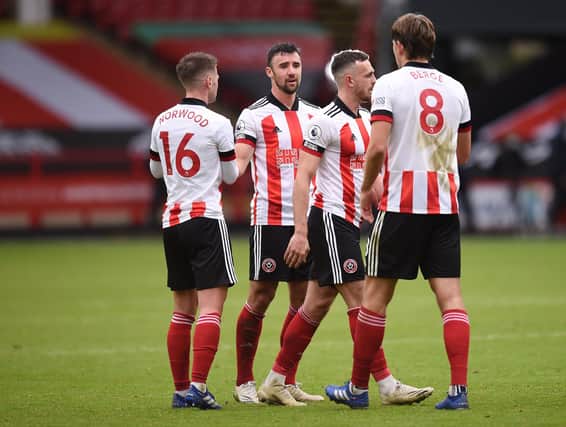Blades players shake hands following the Premier League match between Sheffield United and Fulham at Bramall Lane . (Photo by Oli Scarf - Pool/Getty Images)