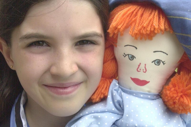 Chloe Lawton, nine,  with a cuddly doll  from the Hillsborough Hawks Gala in 2001