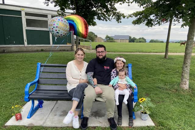A picture of Emma, Ryan, Isla and baby Effie at Ezra's bench in Stannington Park on his third birthday.