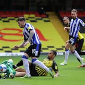 Josh Windass of Sheffield Wednesday is challenged by Daniel Bachmann and William Troost-Ekong of Watford.